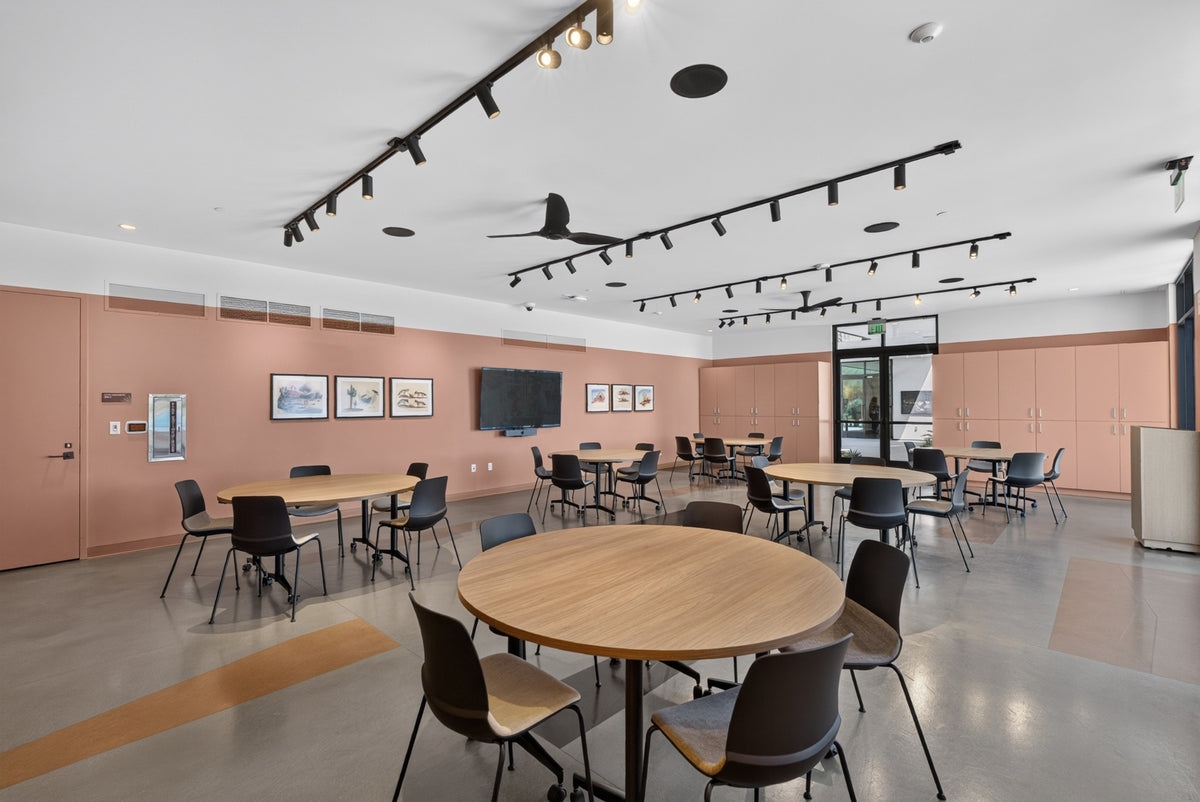 Round tables and chairs in the speaker and event room at Cotino's Artisan Club, photographed by Mark Miller on October 13, 2026.