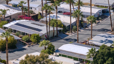 Manufactured homes, covered patios and palms along a Date Palm Country Club street.