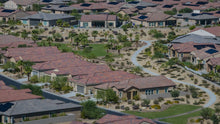 Homes bordering a landscaped community walking path at Del Webb Rancho Mirage, California