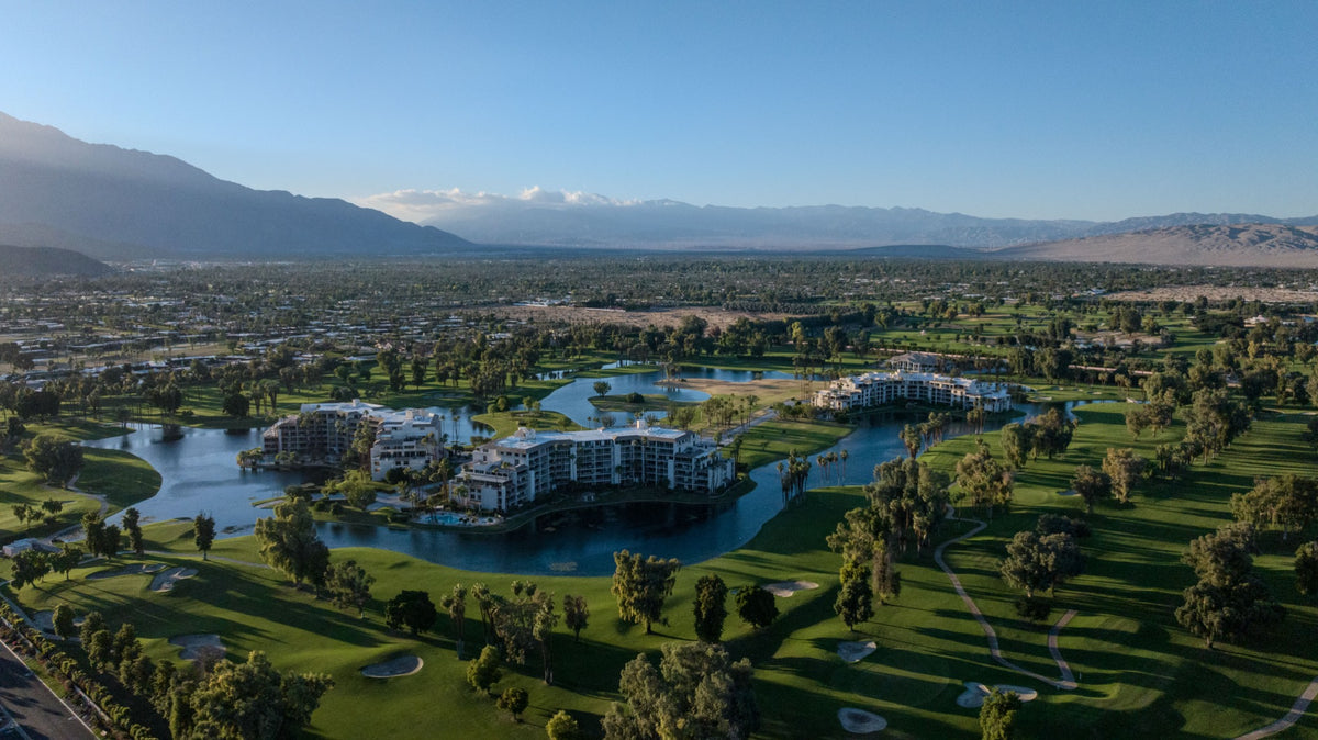 Desert Island’s three condominium buildings surrounded by a lake, golf fairways and mountain views.