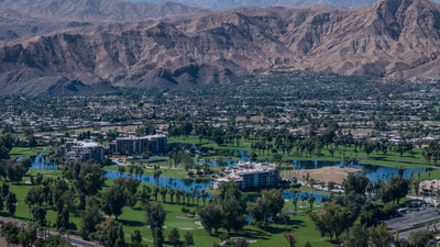 Desert Island’s condominium buildings, lake and golf course with mountains beyond, photographed by Mark Miller on October 13, 2026.