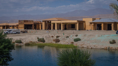 Closer view of Oasis Clubhouse construction across the lake at Desert Retreat, Indio, photographed by Mark Miller on September 25, 2026.