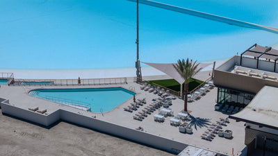Pool and lounge deck beside the DSRT Surf lagoon in Palm Desert, photographed September 10, 2026.