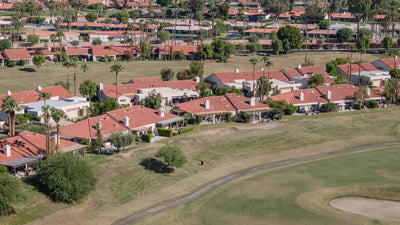 Tile-roof homes and patios bordering a golf fairway at Duna La Quinta