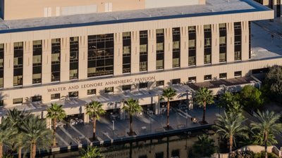 Annenberg Pavilion signage above a palm-lined terrace at Eisenhower Medical Center.