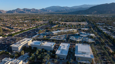 Eisenhower Medical Center campus buildings and parking areas with the mountains beyond.