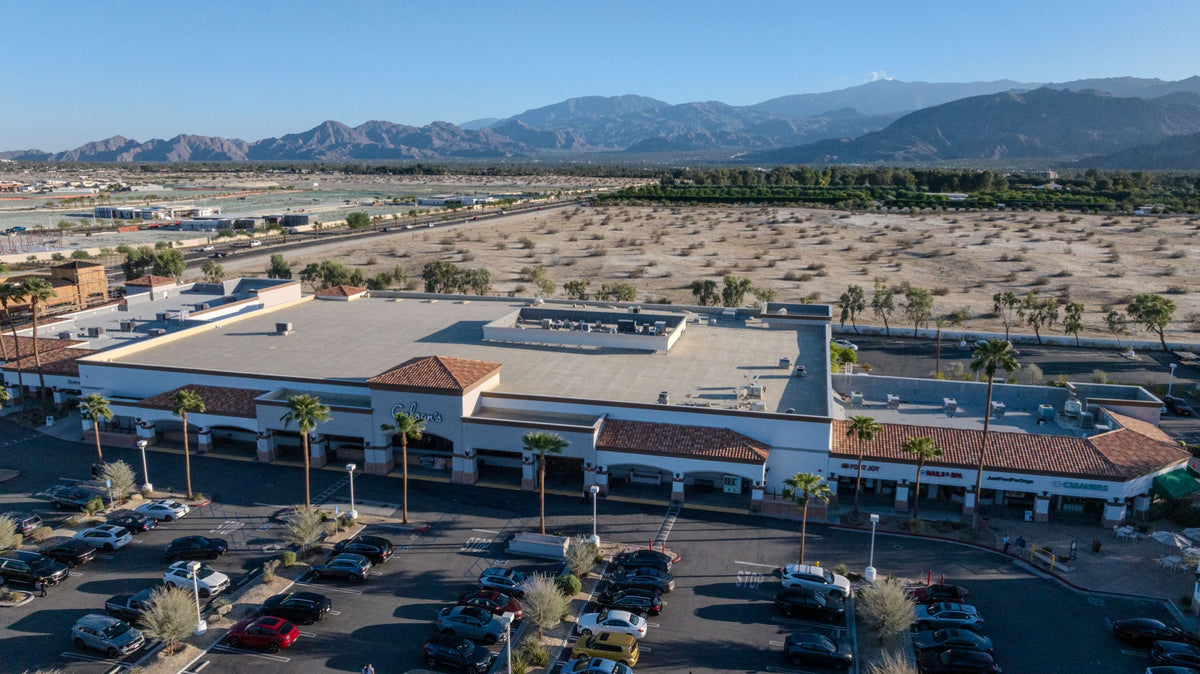 Aerial view of Gelson’s Market in Rancho Mirage, with its storefront, palm-lined parking area and mountains beyond; photographed by Mark Miller on October 13, 2026