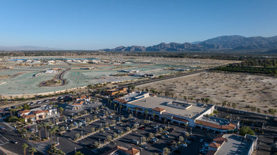 Wide aerial view of Gelson’s Market and its shopping center along Bob Hope Drive in Rancho Mirage, with desert development and mountains beyond; photographed by Mark Miller on October 13, 2026