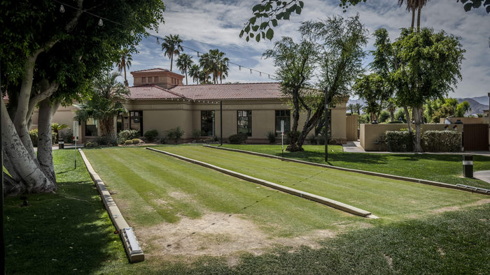 Heritage Palms outdoor bocce ball courts surrounded by mature landscaping