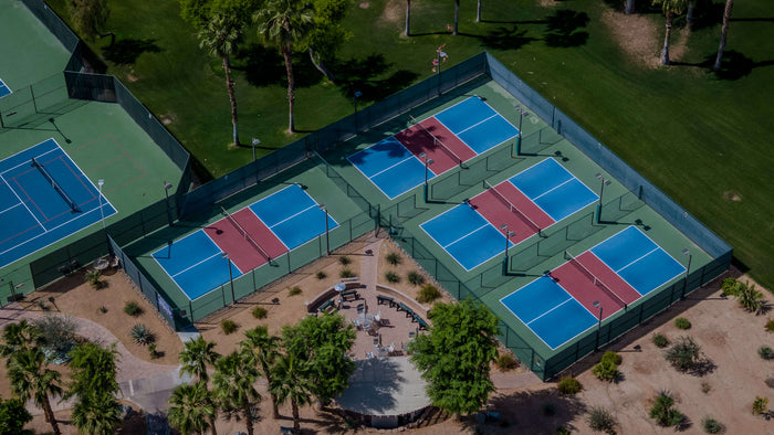 Aerial view of four dedicated pickleball courts and adjacent patio at Heritage Palms Country Club