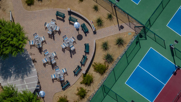 Aerial view of four dedicated pickleball courts and adjacent patio at Heritage Palms Country Club
