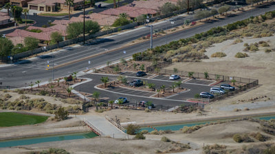 Elevated view of the Indio Badlands trail parking area beside the canal and pedestrian bridge.