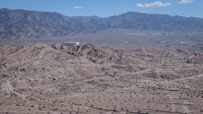 Wide view of the Indio Hills, desert washes, transmission lines and mountain backdrop, photographed by Mark Miller on September 29, 2026.
