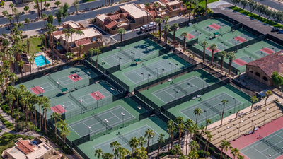 Tennis courts, shaded seating and palms at Ironwood Country Club