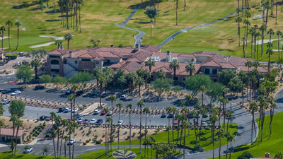 Ironwood Country Club clubhouse beside fairways and palm trees
