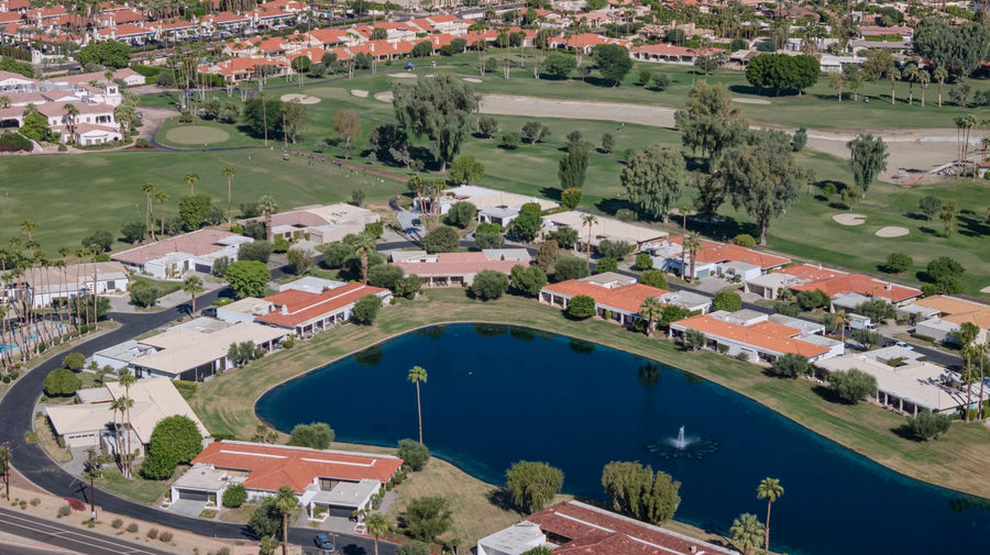 Aerial view of a lake, fairways and surrounding homes at La Quinta Country Club. Photograph by Mark Miller, September 23, 2026.