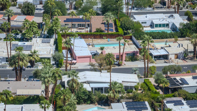 Aerial view of Magnesia Falls Cove homes with private pools, solar panels, and mature landscaping