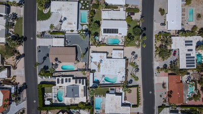 Top-down aerial view of homes, pools, and streets in Magnesia Falls Cove