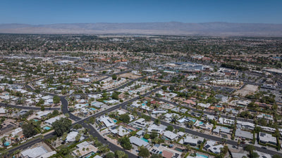 Wide aerial view of Magnesia Falls Cove homes and the surrounding Coachella Valley