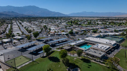 Aerial view of the Palm Desert Greens clubhouse, pool, courts and surrounding neighborhood
