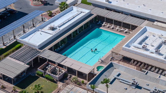Aerial view of a turquoise swimming pool and shaded deck at Palm Desert Greens