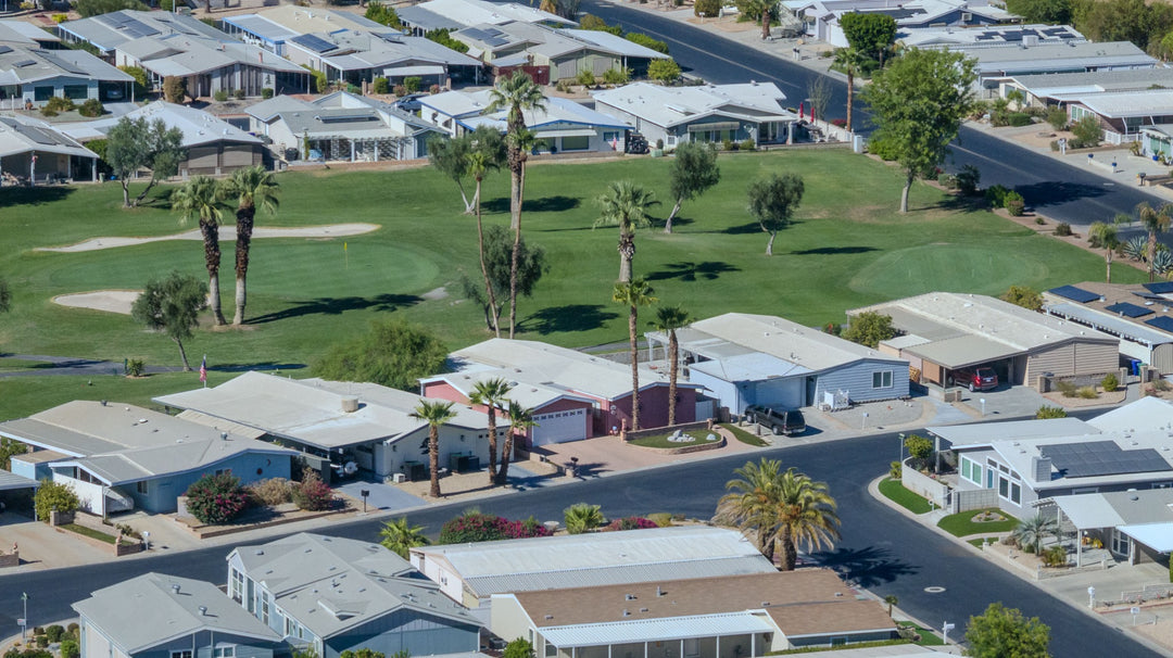 Palm Desert Greens homes bordering a golf fairway with palms and sand bunkers