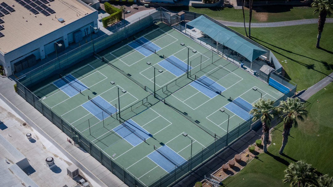 Aerial view of fenced pickleball courts at Palm Desert Greens