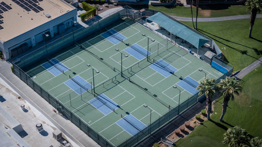 Aerial view of fenced pickleball courts at Palm Desert Greens