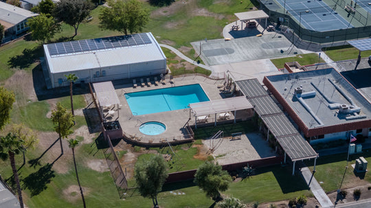 Palm Desert Greens swimming pool and circular spa beside recreation buildings