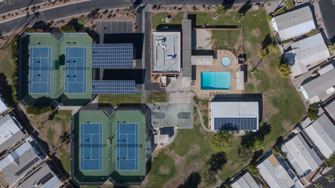 Overhead view of tennis courts, pool, spa and solar-covered parking at Palm Desert Greens