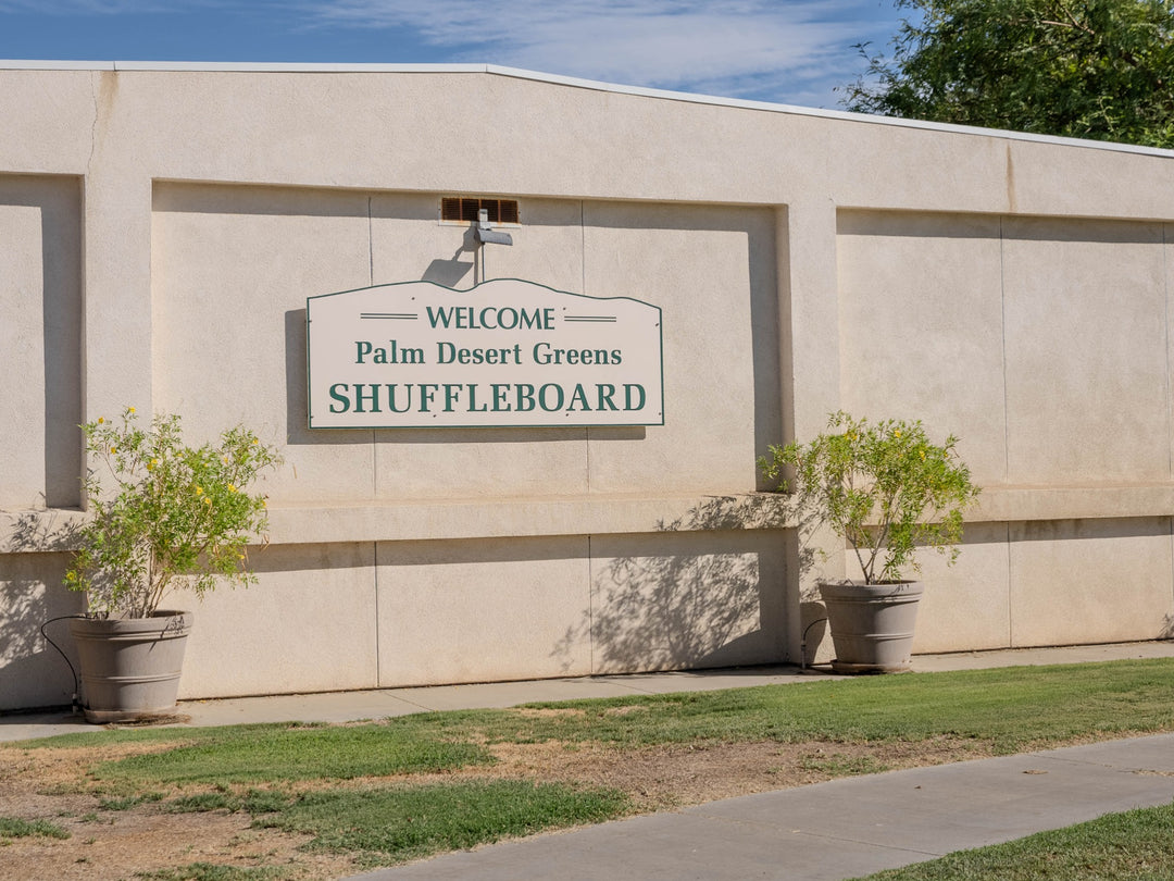 Palm Desert Greens shuffleboard building and welcome sign