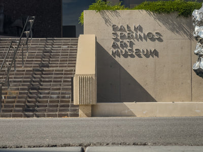 Palm Springs Art Museum lettering, textured walls and entrance steps in afternoon light. Photograph by Mark Miller, October 20, 2026.