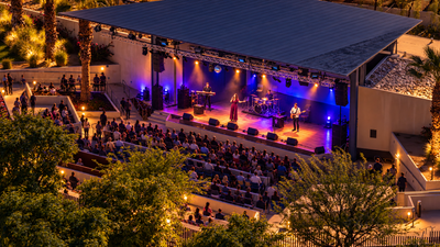 AI visualization of a closer nighttime view of Rancho Mirage Amphitheater, with a singer, musicians and seated concertgoers.
