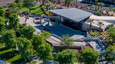 Aerial view of the covered Rancho Mirage Amphitheater stage surrounded by paths, lawns and trees.