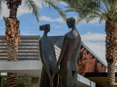 Joined hands and textured bronze figures of Resonance by jd hansen. Photograph by Mark Miller, October 20, 2026.