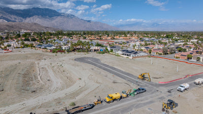 Graded home sites, a new street and construction equipment at Rio del Sol.