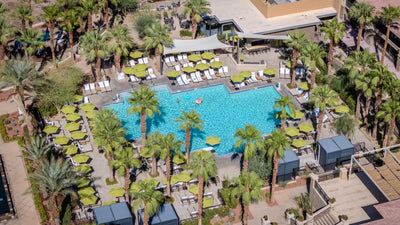 Wide aerial view of the main pool courtyard and green umbrellas at The Ritz-Carlton, Rancho Mirage