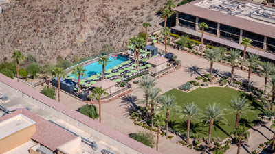 Pool terrace and landscaped lawn beside the desert hillside at The Ritz-Carlton, Rancho Mirage