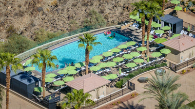 Elevated pool deck with cabanas, palms and green umbrellas at The Ritz-Carlton, Rancho Mirage