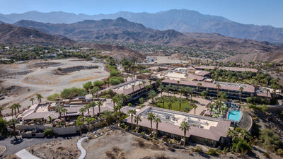 Wide aerial view of The Ritz-Carlton, Rancho Mirage against the surrounding desert mountains