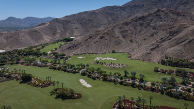 Golf fairways and palms at the foot of a steep desert mountain at Sensei Porcupine Creek.