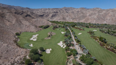 Expansive fairways, sand bunkers and palm-lined paths beneath desert mountains at Sensei Porcupine Creek.