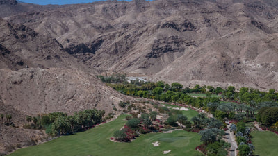 Rocky desert ridges rising above landscaped resort grounds at Sensei Porcupine Creek.