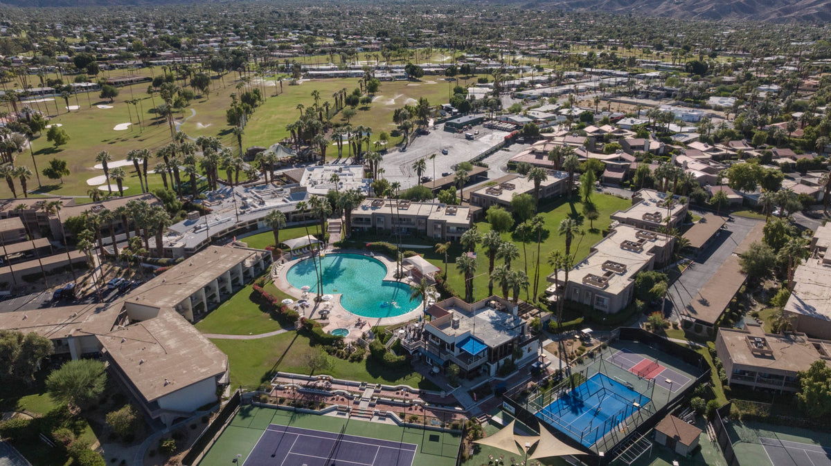 Aerial view of Shadow Mountain Resort's figure-eight pool, courts and surrounding Palm Desert neighborhood, photographed by Mark Miller on October 15, 2026.
