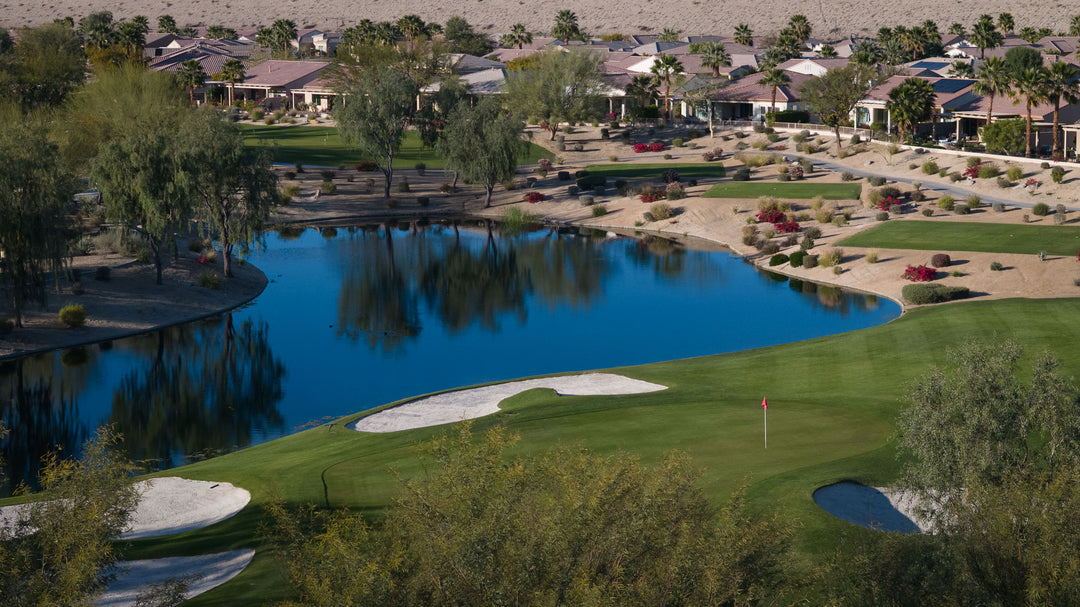 Golf course with a lake and residential area in the background at sun city shadow hills ca