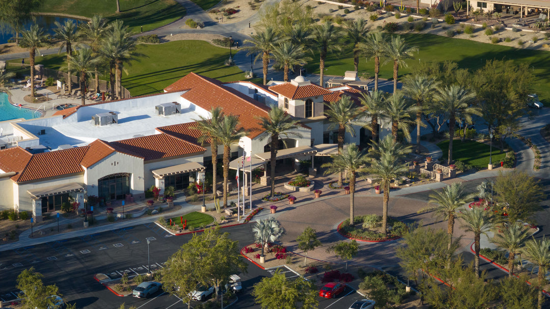 Aerial view of a santa rosa clubhouse with palm trees and a pool area in sun city shadow hills ca