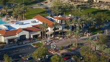 Aerial view of a santa rosa clubhouse with palm trees and a pool area in sun city shadow hills ca
