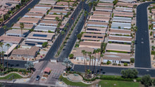 Gated entrance, palm-lined streets and manufactured homes at Suncrest Country Club in Palm Desert. Aerial photo by Mark Miller, September 10, 2026.