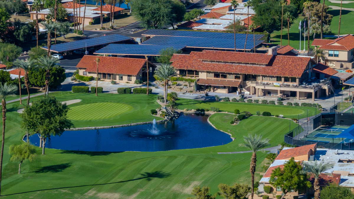 Sunrise Country Club clubhouse overlooking a lake and golf course