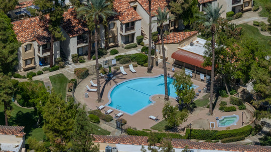 Courtyard swimming pool and spa with lounge chairs and palm trees at The Regent Palm Desert. Photo by Mark Miller, September 10, 2026.